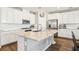 Modern kitchen with white cabinets, stainless steel appliances, and an island with granite countertops at 10801 Far Country Ave, Las Vegas, NV 89129