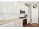 Bright kitchen with white cabinets, stainless steel appliances, and granite countertops at 10801 Far Country Ave, Las Vegas, NV 89129