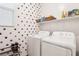 Functional laundry room featuring a white washer and dryer set, overhead shelving, and a window at 10801 Far Country Ave, Las Vegas, NV 89129