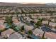 An elevated view showcases an array of houses complemented by lush landscapes, private pools, and curvilinear street design at 11158 Antonine Wall Ct, Las Vegas, NV 89141