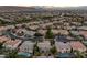 A sprawling aerial view of residences featuring tiled roofs, mature landscaping, and serene pools in a Primary-planned community at 11158 Antonine Wall Ct, Las Vegas, NV 89141