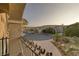 Balcony view with ornate railings overlooking houses, trees, and a landscaped street at 11158 Antonine Wall Ct, Las Vegas, NV 89141