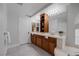 Bathroom with dual sink vanity with wood cabinets and tile floor at 11158 Antonine Wall Ct, Las Vegas, NV 89141