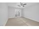 Bedroom with neutral carpet, ceiling fan, and a sliding glass door with shutter blinds at 11158 Antonine Wall Ct, Las Vegas, NV 89141