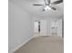 Bedroom featuring neutral carpet, ceiling fan, closet and an open door at 11158 Antonine Wall Ct, Las Vegas, NV 89141