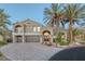 Stunning two-story home with tile roof, palm trees, arched entry, and brick driveway at 11158 Antonine Wall Ct, Las Vegas, NV 89141