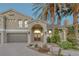 Attractive two-story home with palm trees, a tile roof and brick driveway at 11158 Antonine Wall Ct, Las Vegas, NV 89141