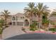 Beautiful front exterior showcasing a circular driveway, well-manicured landscape and mature palm trees at 11158 Antonine Wall Ct, Las Vegas, NV 89141