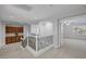 Upstairs hallway featuring wood cabinets and a view of the ceiling fan in the bedroom at 11158 Antonine Wall Ct, Las Vegas, NV 89141