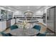 Bright kitchen with white cabinetry, stainless steel appliances, and a granite island, virtually staged at 11158 Antonine Wall Ct, Las Vegas, NV 89141