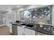 Bright kitchen features granite counters, a stainless steel dishwasher and a view to the backyard at 11158 Antonine Wall Ct, Las Vegas, NV 89141