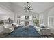 Bright, virtually staged living room with high ceilings, fireplace, and large windows with plantation shutters at 11158 Antonine Wall Ct, Las Vegas, NV 89141