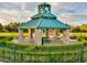 Stone and green-roofed park pavilion offers shaded picnic tables and seating surrounded by lush landscaping at 11158 Antonine Wall Ct, Las Vegas, NV 89141