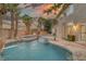 Beautiful backyard pool and spa with rock features, mature landscaping and outdoor bar area at 11158 Antonine Wall Ct, Las Vegas, NV 89141