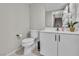 Bright bathroom featuring a toilet, floating vanity with white cabinets, and stylish mirror at 11230 Hidden Peak Ave # 207, Las Vegas, NV 89135