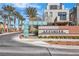 Community entrance with desert landscaping and modern signage under blue skies at 11230 Hidden Peak Ave # 207, Las Vegas, NV 89135