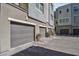 View of new construction townhomes with attached garages and gray brick pavers at 11230 Hidden Peak Ave # 207, Las Vegas, NV 89135