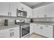 Close-up of modern kitchen area with stainless steel appliances, ample counter space and white cabinets at 11230 Hidden Peak Ave # 207, Las Vegas, NV 89135