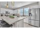 Bright kitchen featuring stainless steel appliances, gray counter tops, and an island with bar stool seating at 11230 Hidden Peak Ave # 207, Las Vegas, NV 89135