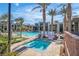 Relaxing community pool area with lounge chairs, a hot tub, palm trees, and well-maintained landscaping at 11230 Hidden Peak Ave # 207, Las Vegas, NV 89135