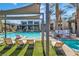 Community pool area with lounge chairs and landscaping offering plenty of space for residents to socialize at 11230 Hidden Peak Ave # 207, Las Vegas, NV 89135