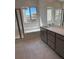 Bright bathroom featuring double sinks, a large window, and a separate shower and tub at 145 Medianoche St, Las Vegas, NV 89138