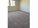 This bedroom has neutral carpet and natural lighting at 145 Medianoche St, Las Vegas, NV 89138