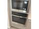 Stainless steel microwave and oven with digital displays sit above gray drawers in the kitchen at 145 Medianoche St, Las Vegas, NV 89138