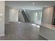 Open-concept living room showcasing tile flooring, a staircase, and a modern, neutral color palette at 145 Medianoche St, Las Vegas, NV 89138