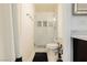 Well-lit bathroom featuring a tiled shower with glass door, and a white toilet at 200 E Desert Rose Dr, Henderson, NV 89015