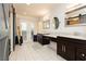 Elegant bathroom showcasing double vanities, marble countertops, barn door, and access to an outdoor patio at 200 E Desert Rose Dr, Henderson, NV 89015