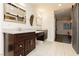 Stylish bathroom featuring dual vanities with marble counters and a barn door to the bedroom at 200 E Desert Rose Dr, Henderson, NV 89015