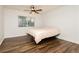 Bright bedroom featuring hardwood floors, ceiling fan, and a window with natural light at 200 E Desert Rose Dr, Henderson, NV 89015