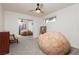 Cozy bedroom with a ceiling fan and a mirrored closet door at 200 E Desert Rose Dr, Henderson, NV 89015