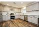 Modern kitchen featuring stainless steel appliances, farm sink, and ample cabinet space at 200 E Desert Rose Dr, Henderson, NV 89015