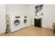 Bright laundry room featuring a modern Samsung washer and dryer set and a dark wood vanity at 200 E Desert Rose Dr, Henderson, NV 89015