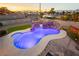 Custom in-ground pool with waterfall feature and rock slide, perfect for entertaining at 200 E Desert Rose Dr, Henderson, NV 89015