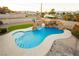 Inviting backyard pool with rock waterfall and slide, perfect for outdoor fun at 200 E Desert Rose Dr, Henderson, NV 89015