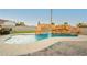 Inviting backyard pool featuring a custom rock waterfall and slide, perfect for relaxation and entertainment at 200 E Desert Rose Dr, Henderson, NV 89015