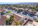 Expansive aerial view of a neighborhood with tile roofs, palm trees, and mountain views at 2045 Summit Pointe Dr, Las Vegas, NV 89117