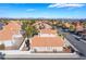 Expansive aerial view of a single-story home with a terra cotta roof, desert landscaping, and views of the Las Vegas skyline at 2045 Summit Pointe Dr, Las Vegas, NV 89117