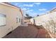 Backyard featuring a concrete patio, gravel landscaping, mature palm trees, and stucco walls at 2045 Summit Pointe Dr, Las Vegas, NV 89117