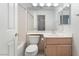 A bathroom with a toilet, a sink with a wood cabinet, and a bathtub behind the door at 2045 Summit Pointe Dr, Las Vegas, NV 89117