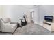 Carpeted bedroom featuring a comfortable chair, TV, and exercise bike at 2045 Summit Pointe Dr, Las Vegas, NV 89117