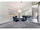 Elegant dining room with a crystal chandelier, mirrored wall accent, and seating for six at 2045 Summit Pointe Dr, Las Vegas, NV 89117