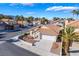 Charming single-story home with a terra cotta roof, desert landscaping, and an attached two-car garage in a gated community at 2045 Summit Pointe Dr, Las Vegas, NV 89117