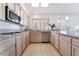 Spacious kitchen featuring updated appliances, granite counters, tile floors and pendant lighting at 2045 Summit Pointe Dr, Las Vegas, NV 89117