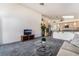 Open-concept living room featuring neutral decor and seamless flow into the kitchen area at 2045 Summit Pointe Dr, Las Vegas, NV 89117