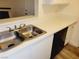 Close-up of a stainless steel sink and countertop with a black dishwasher in a bright kitchen at 221 Mission Newport Ln # 208, Las Vegas, NV 89107