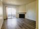 Inviting living room with modern floors, fireplace and sliding glass door to patio at 221 Mission Newport Ln # 208, Las Vegas, NV 89107